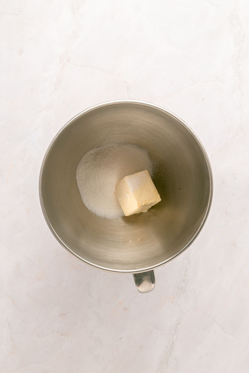 sugar and butter in a metal bowl on table