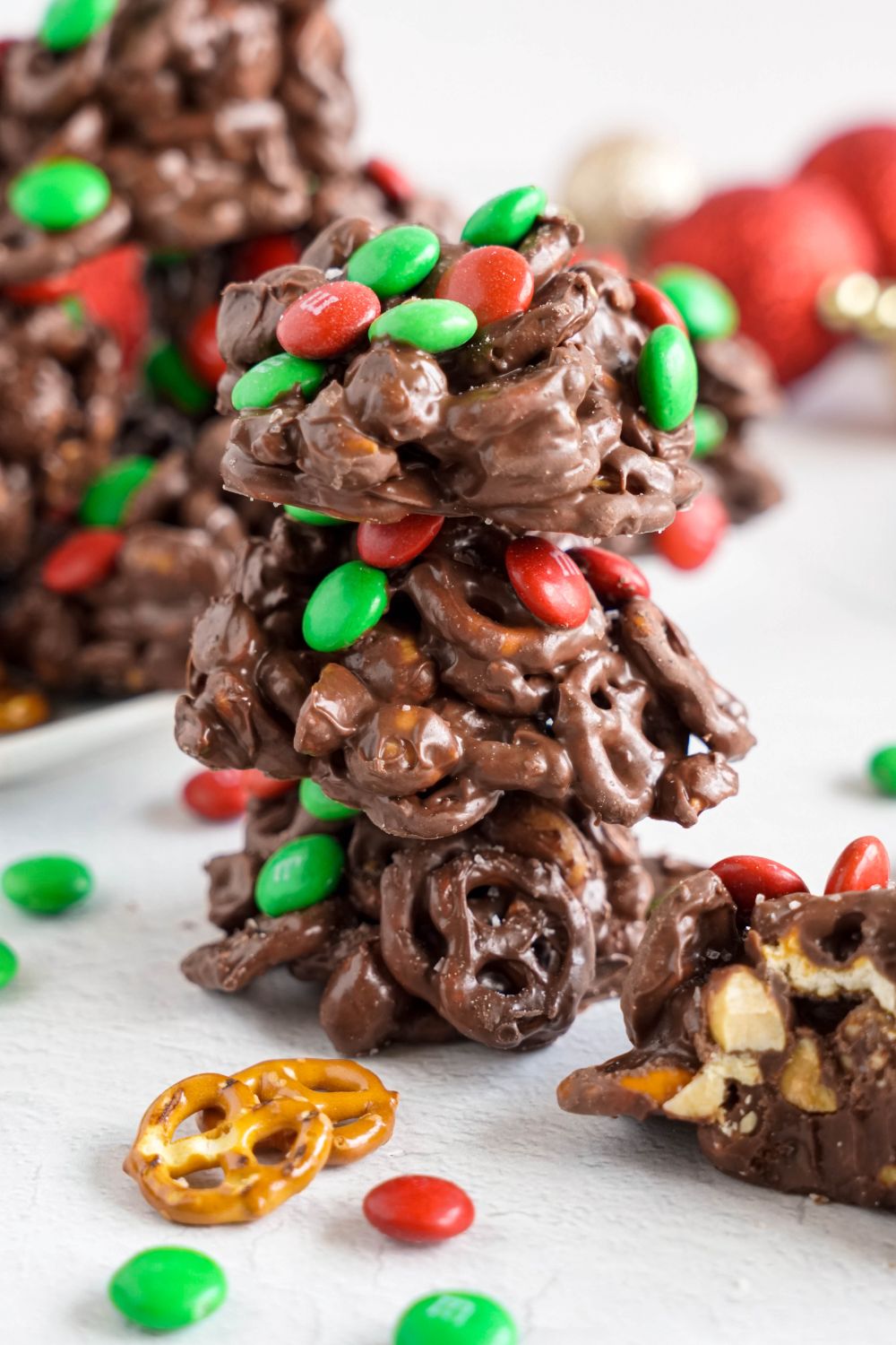 stack of Crockpot Chocolate Pretzel Christmas Candy and more around the table