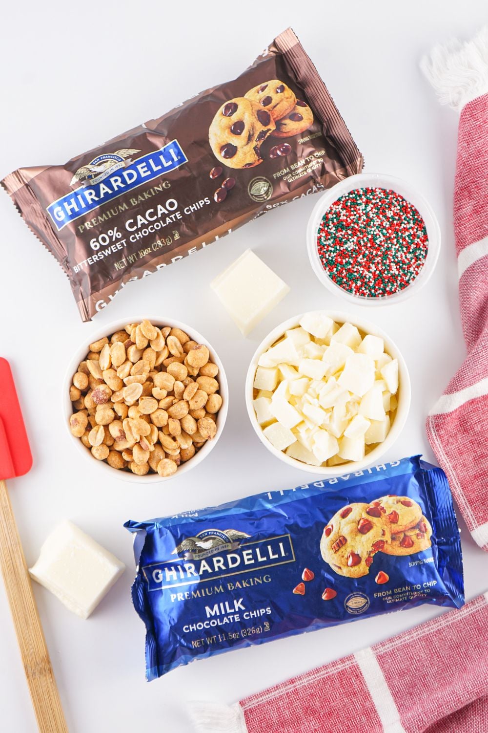 Crockpot Christmas Candy ingredients on a white table in single serve bowls and bags of chocolates