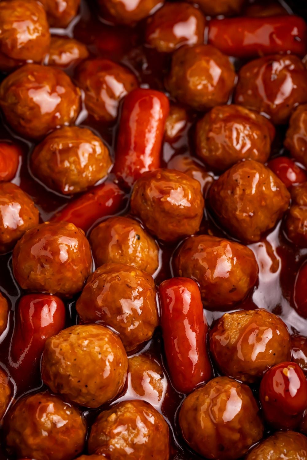 close up look of Crockpot Teriyaki BBQ Cocktail Meatballs & Lil Smokies in a crockpot on table 