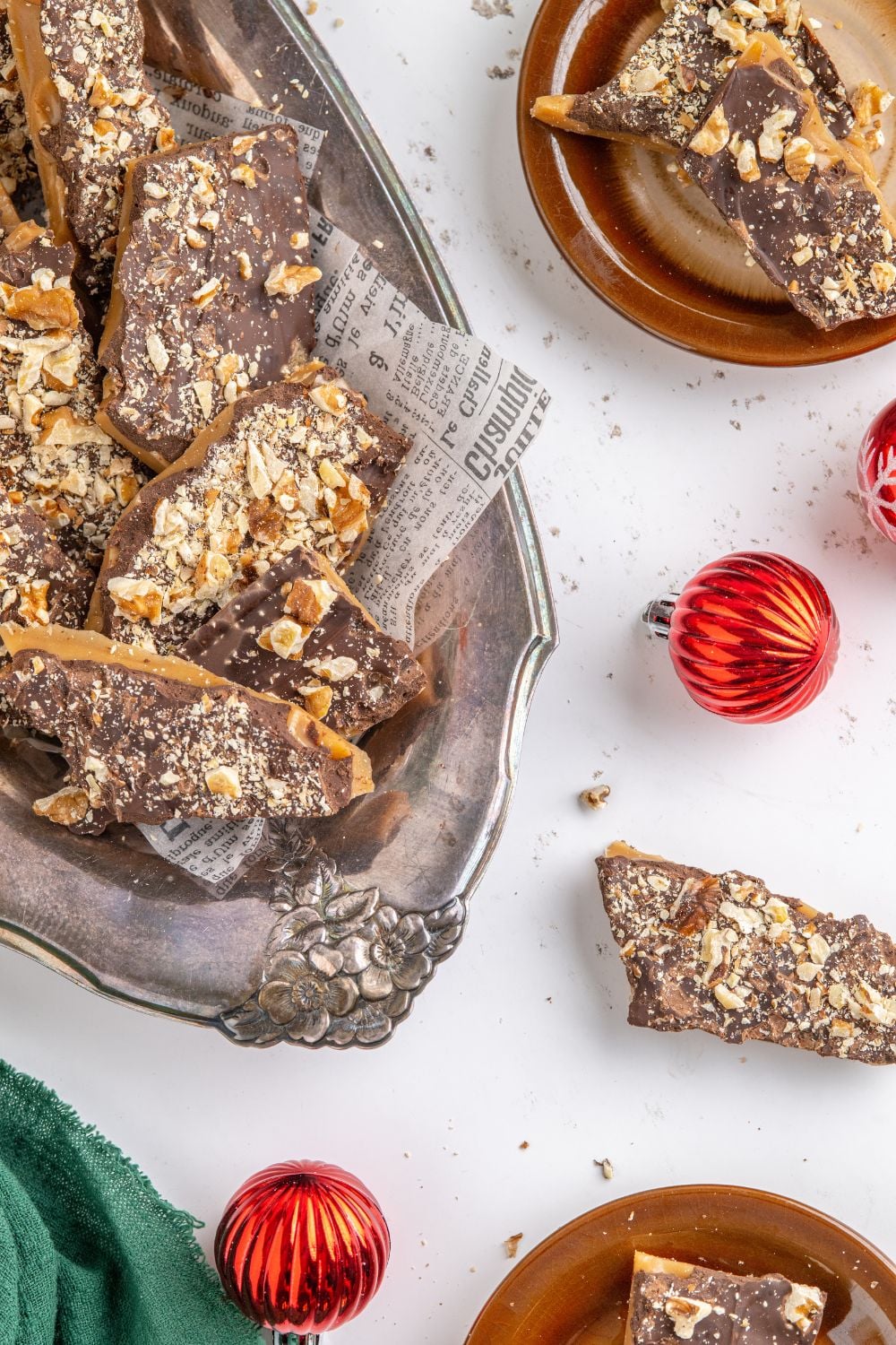 English Toffee on a platter with Christmas ornaments around the table