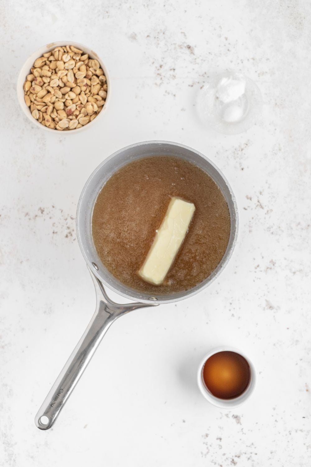 Homemade Peanut Brittle being made in saucepan with butter in it