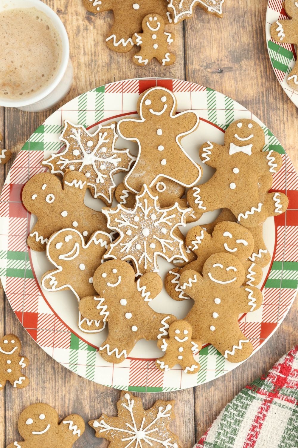 colorful plate full of Christmas gingerbread cookies all over and different shapes 