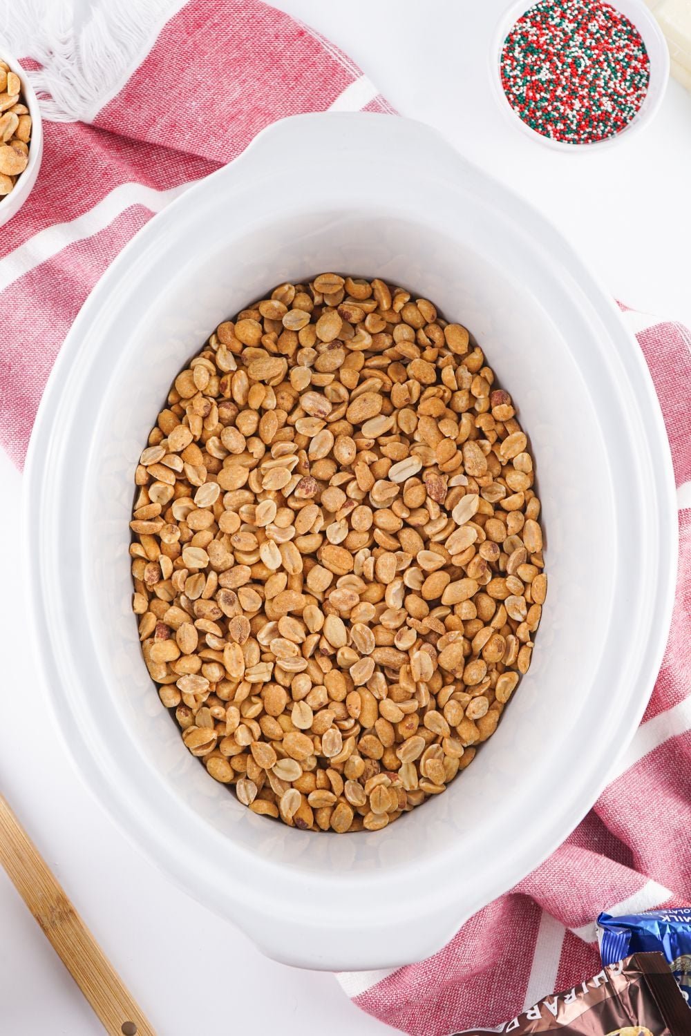 peanuts in a white crockpot on table
