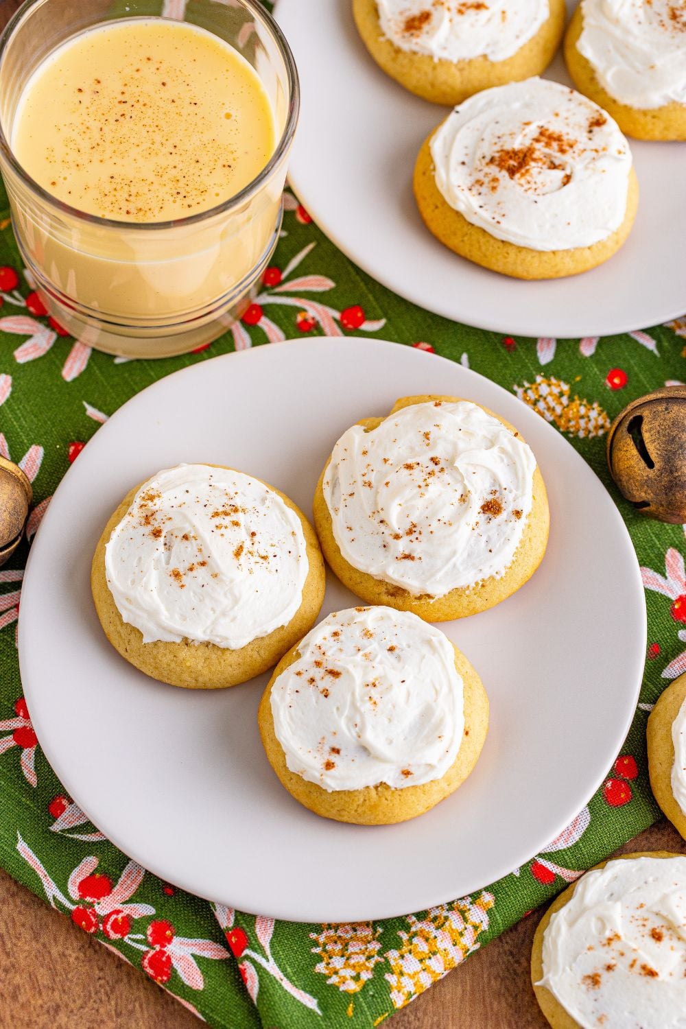 soft baked eggnog cookies with plates and eggnog on the table