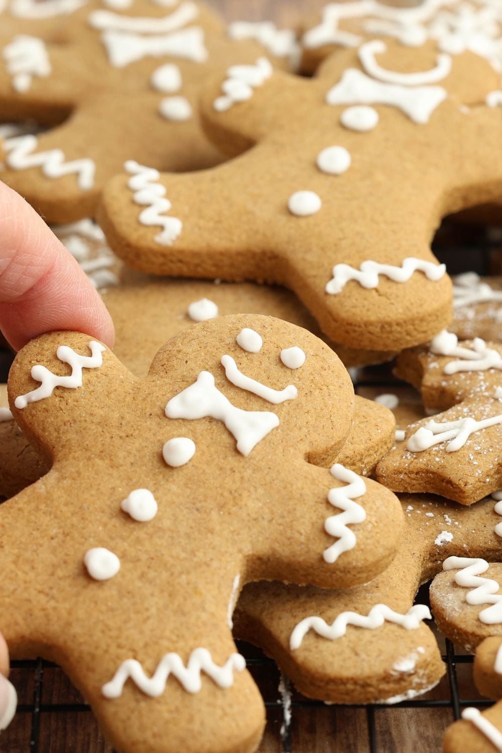 hand grabbing one of the cookies scattered on the table