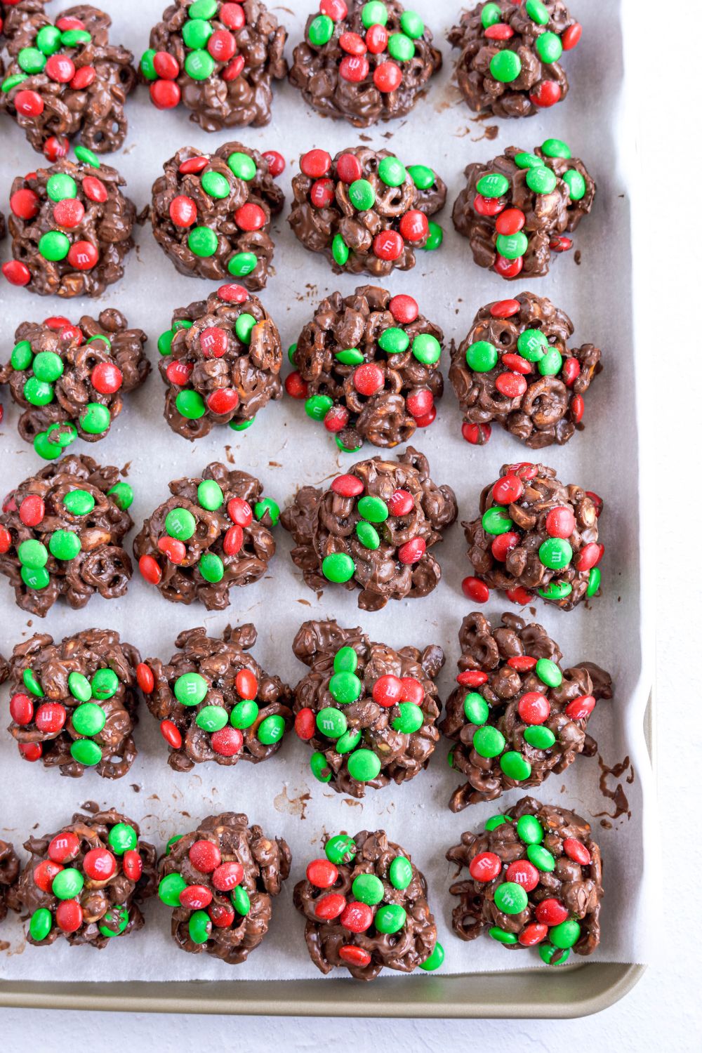 Crockpot Chocolate Pretzel Christmas Candy scooped into piles on a cooling tray