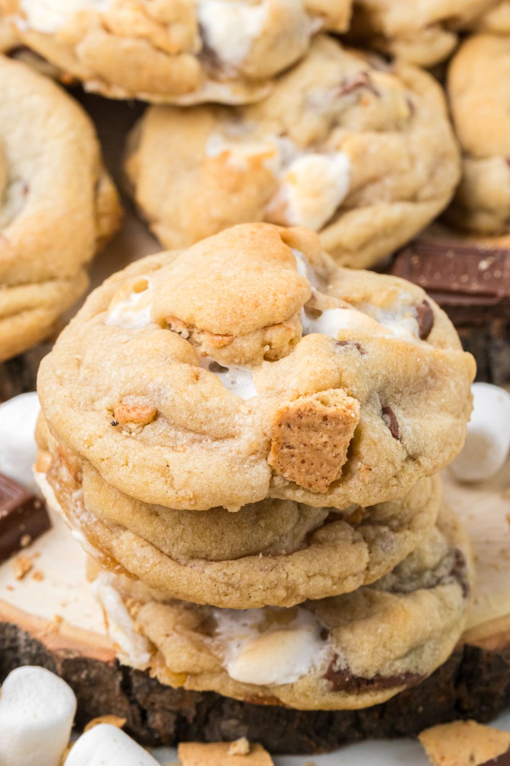 stack of S'mores Cookies and then more cookies around the table with mini marshmallows