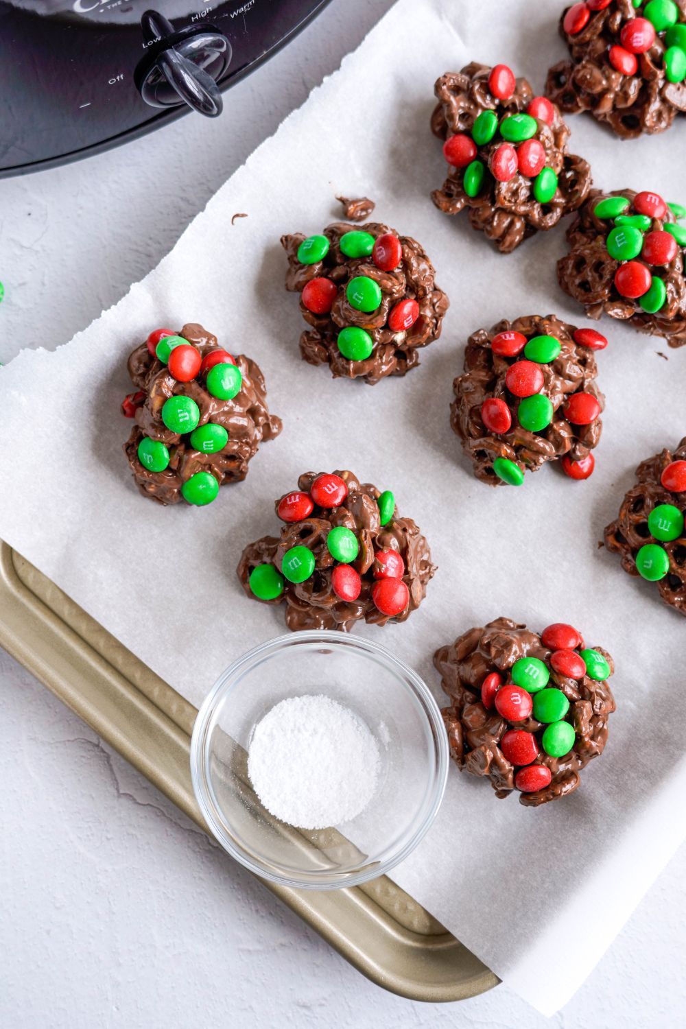 Crockpot Chocolate Pretzel Christmas Candy on a tray with a bowl of salt