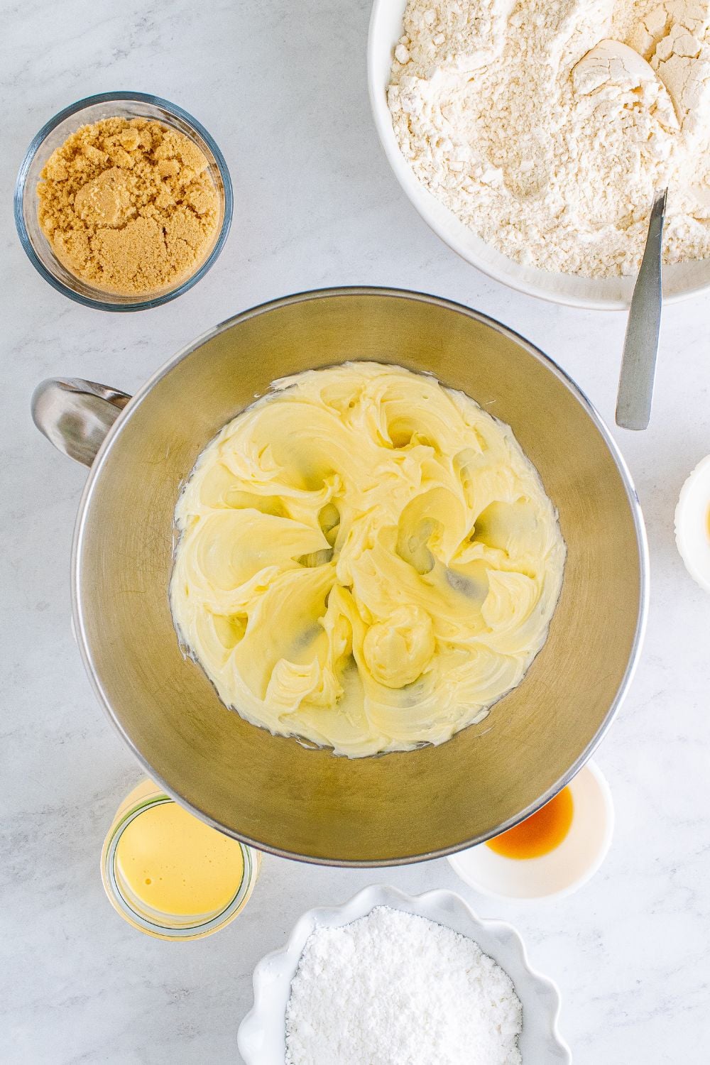 creamed butter in a metal bowl on table
