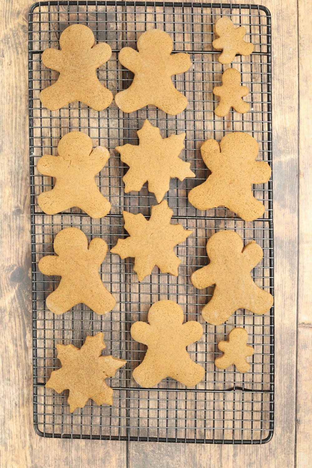 baked Christmas gingerbread cookies on a cooling rack on table 
