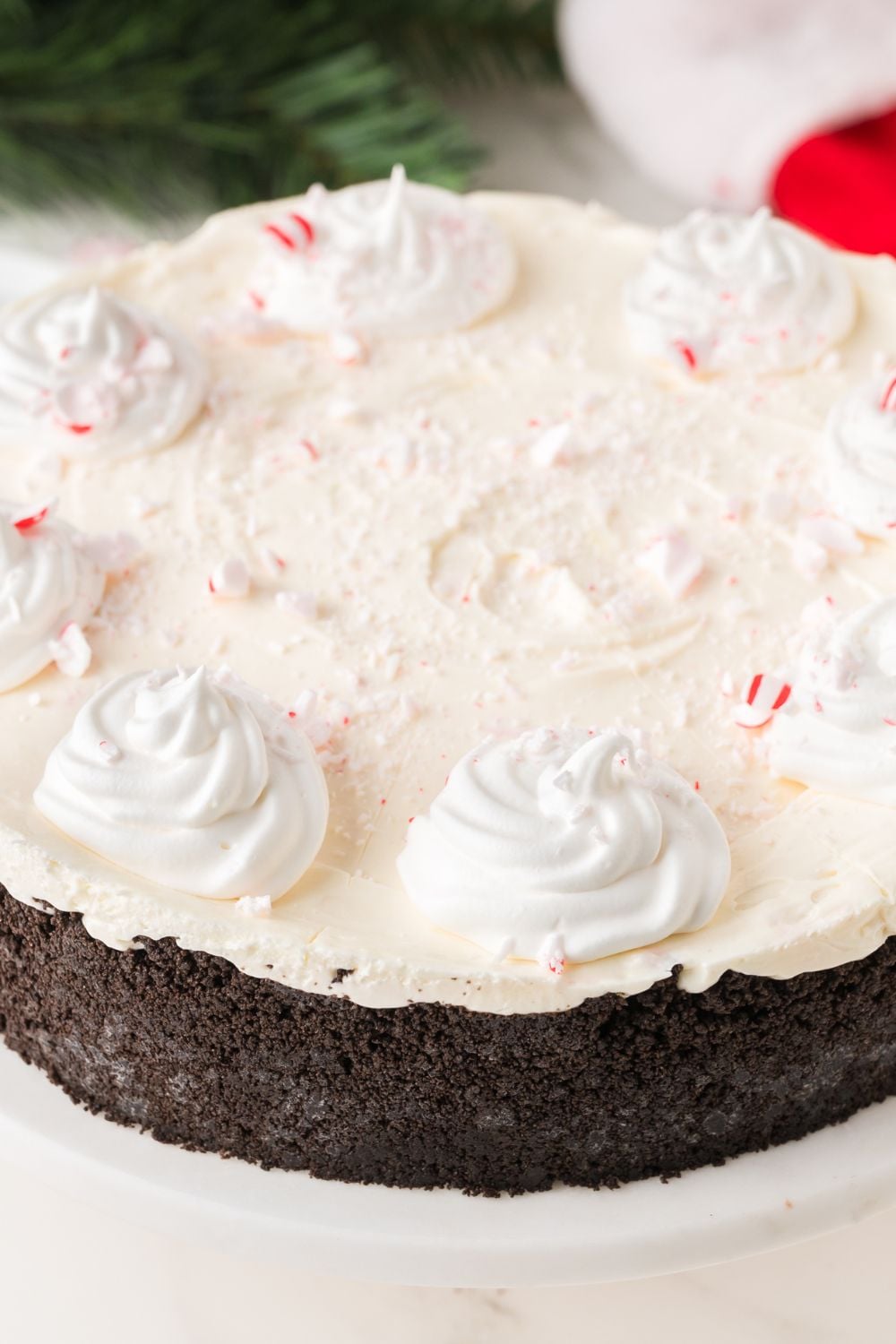 No Bake Peppermint Cheesecake on platter topped with candy canes 