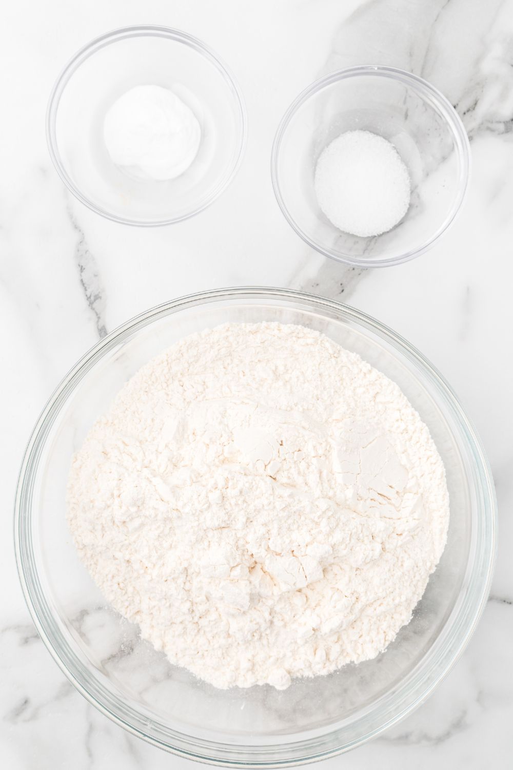dry ingredients in bowl on marble counter in glass bowls