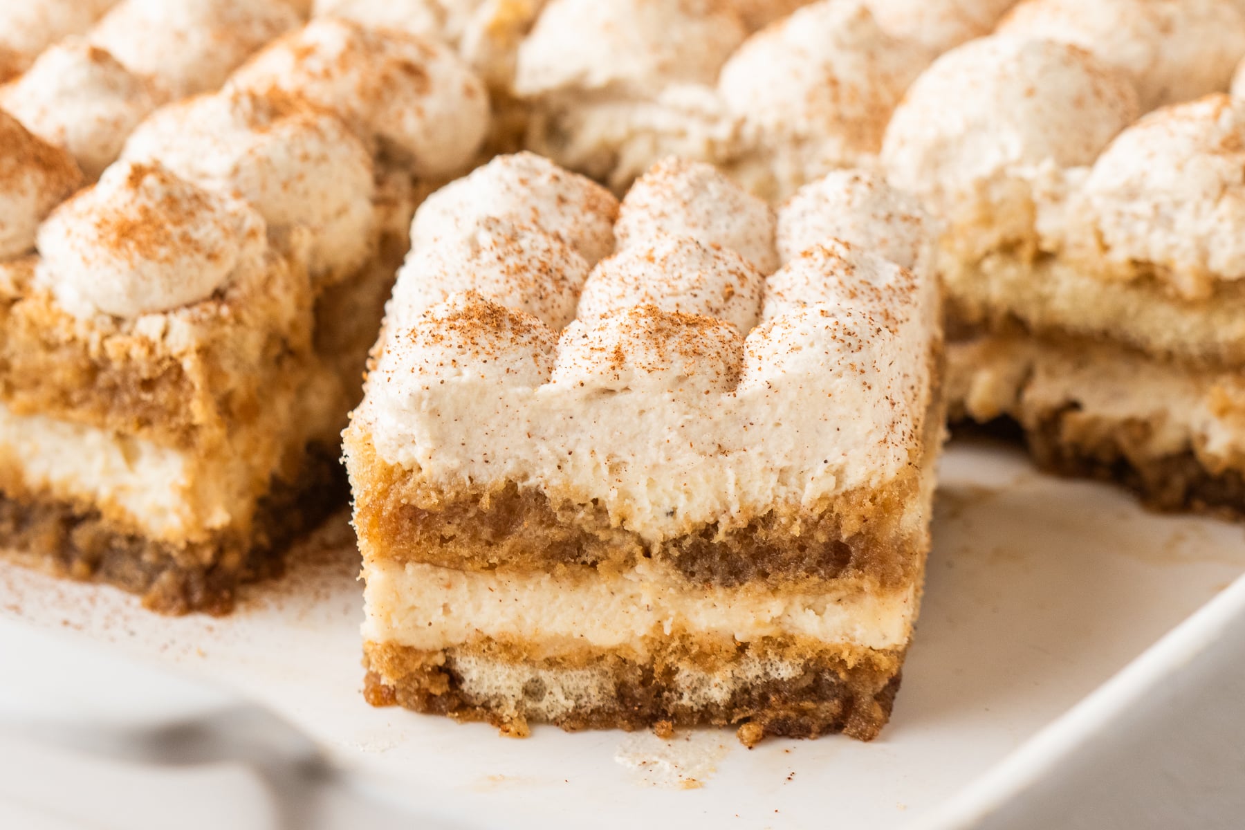 No Bake Eggnog Tiramisu sliced on a white platter 