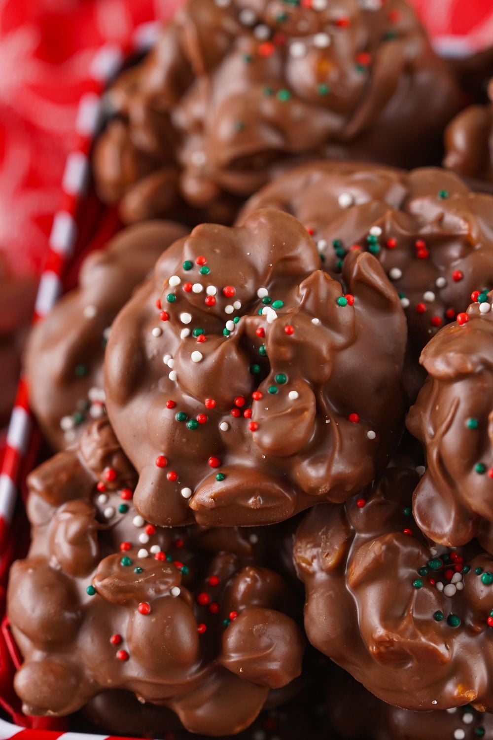 close up of a stack of Crockpot Christmas Candy with sprinkles on top