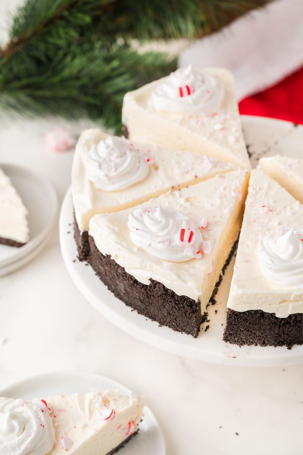 slices of No Bake Peppermint Cheesecake on a pie platter on the table 