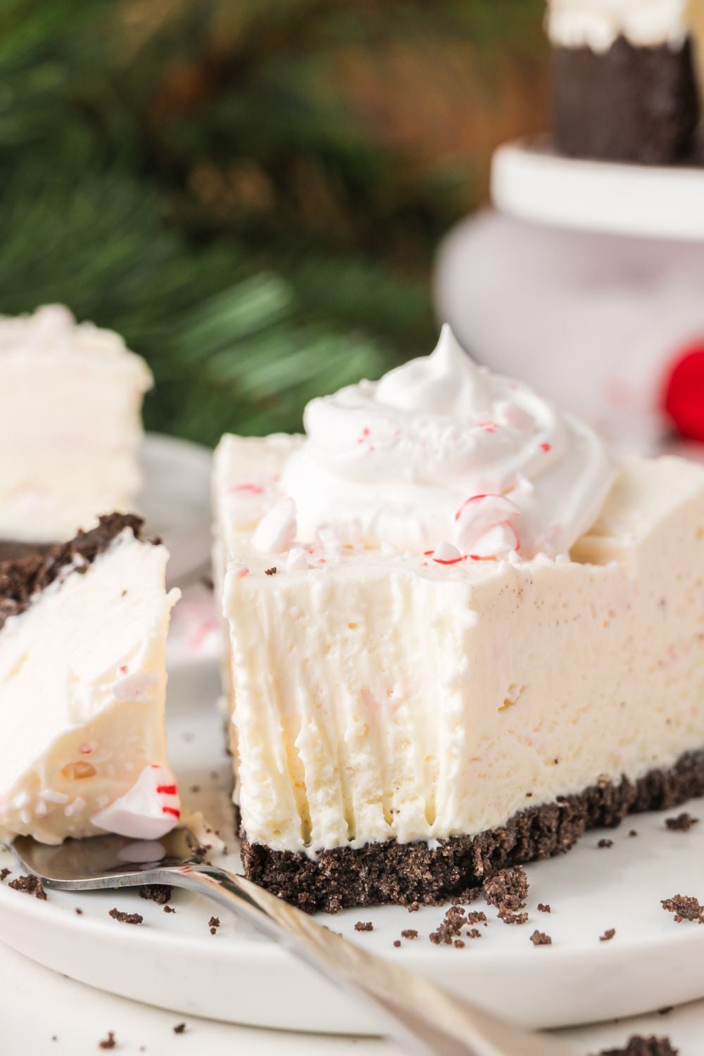 slice of No Bake Peppermint Cheesecake with a fork to side of plate