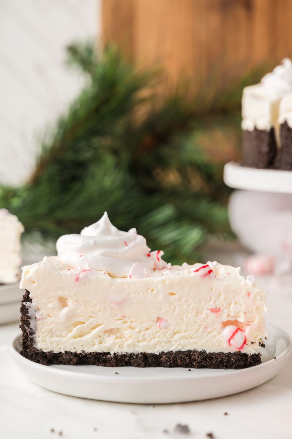 slice of No Bake Peppermint Cheesecake on a white plate on the table 