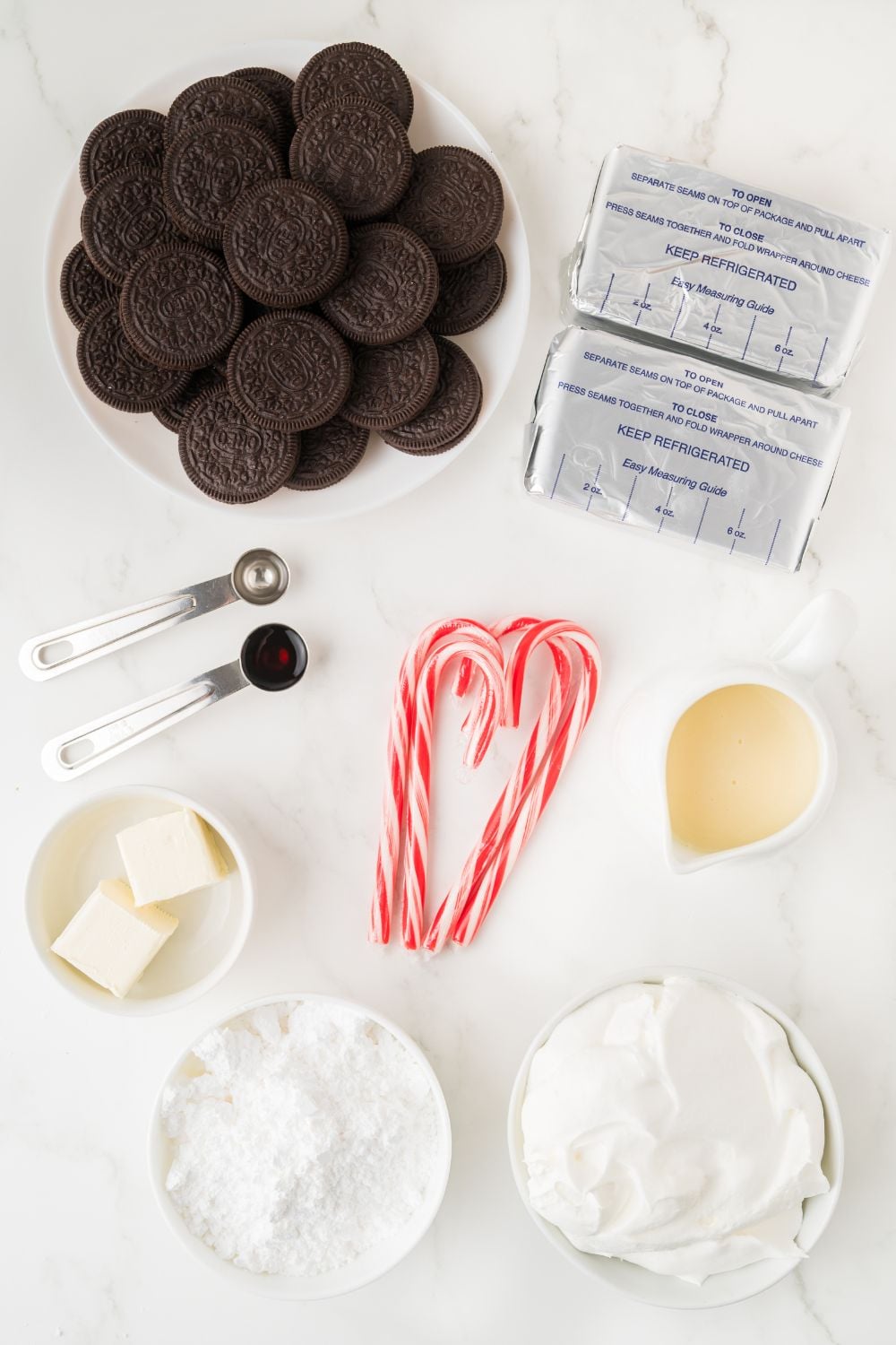 all the ingredients for No Bake Peppermint Cheesecake on a white table 