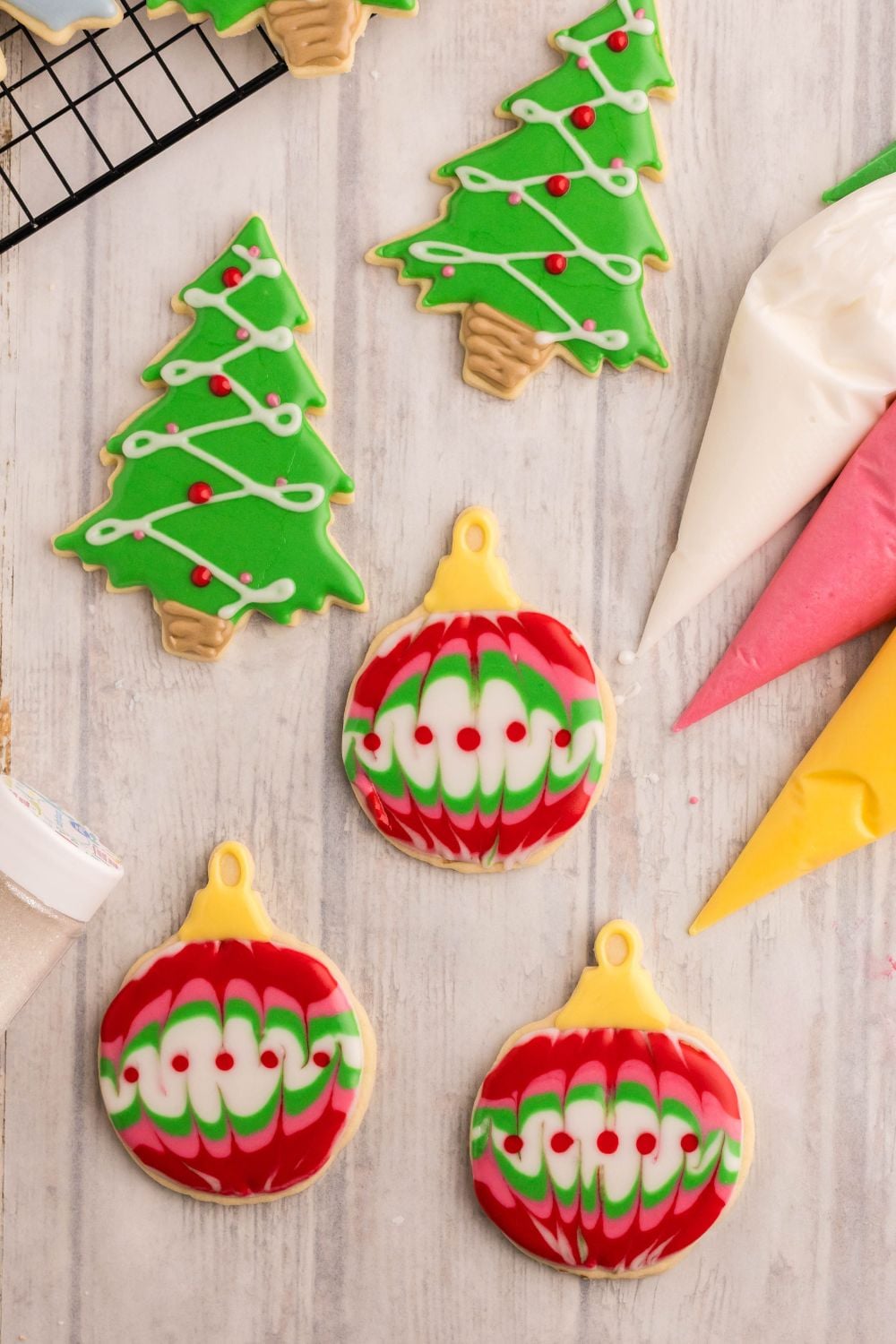 decorated sugar cookies with royal icing that are themed like Christmas ornaments and trees