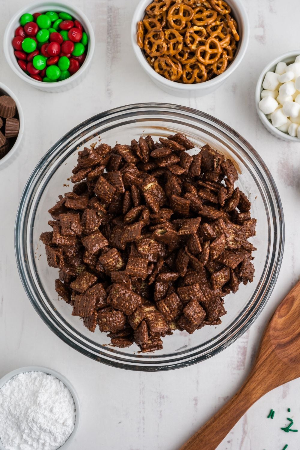 chocolate coated chex cereal in a glass bowl on table