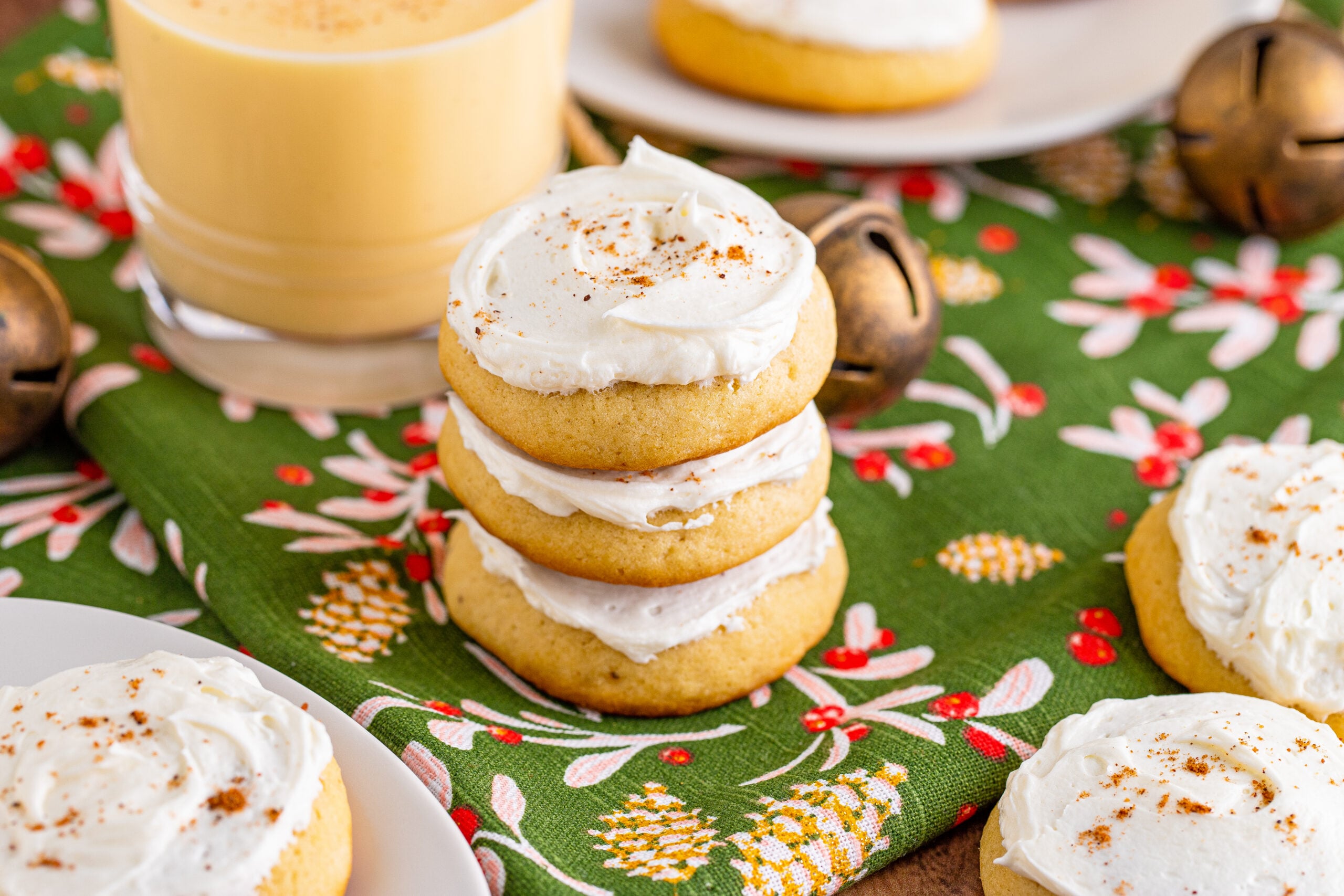 Soft Frosted Eggnog Cookies stacked on a table