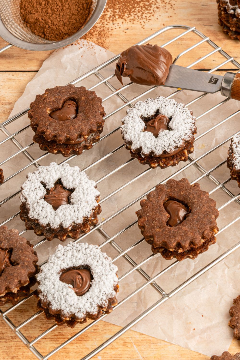 Chocolate Linzer Cookies on a cooling rack 