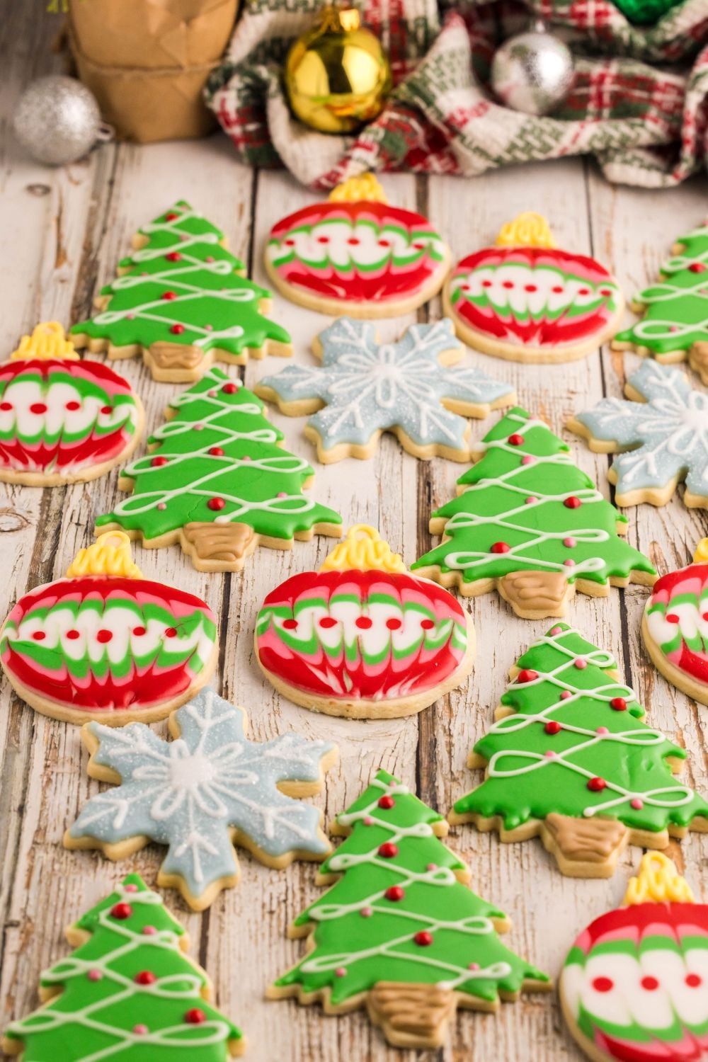 view of Decorated Sugar Cookies on table that are snowflakes, ornaments, and Christmas trees