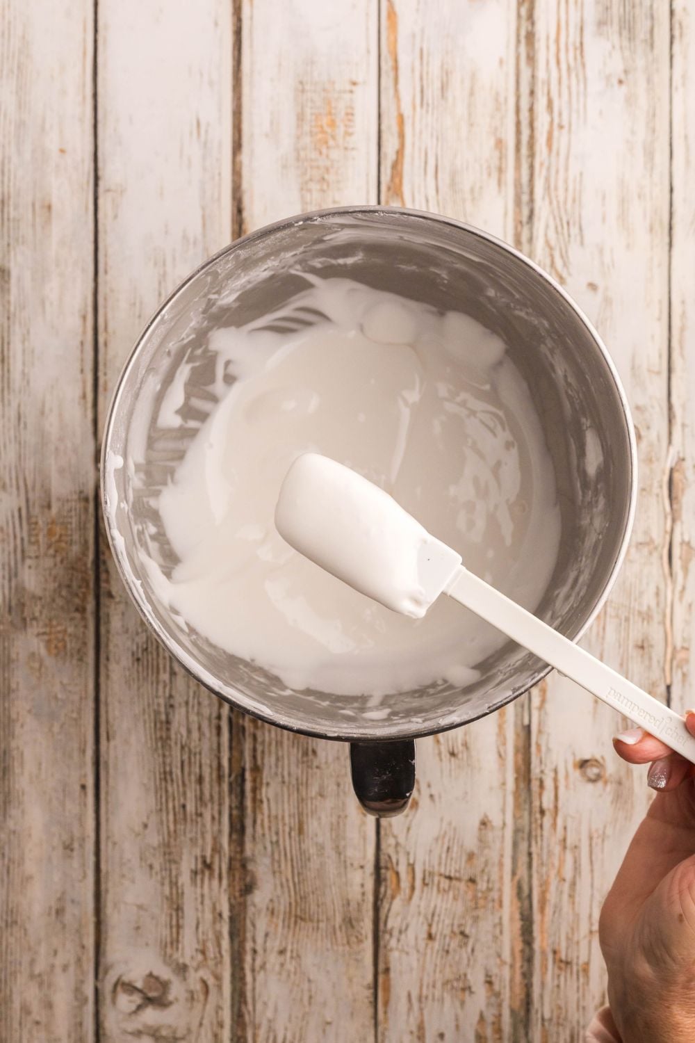 royal icing in a metal bowl with statula