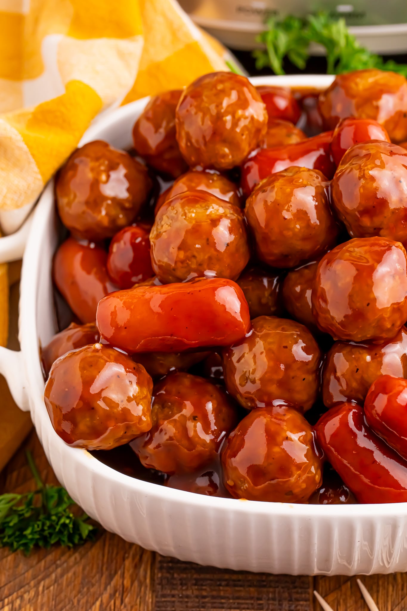 up close shot of Crockpot Teriyaki BBQ Cocktail Meatballs & Lil Smokies in a large white serving bowl 