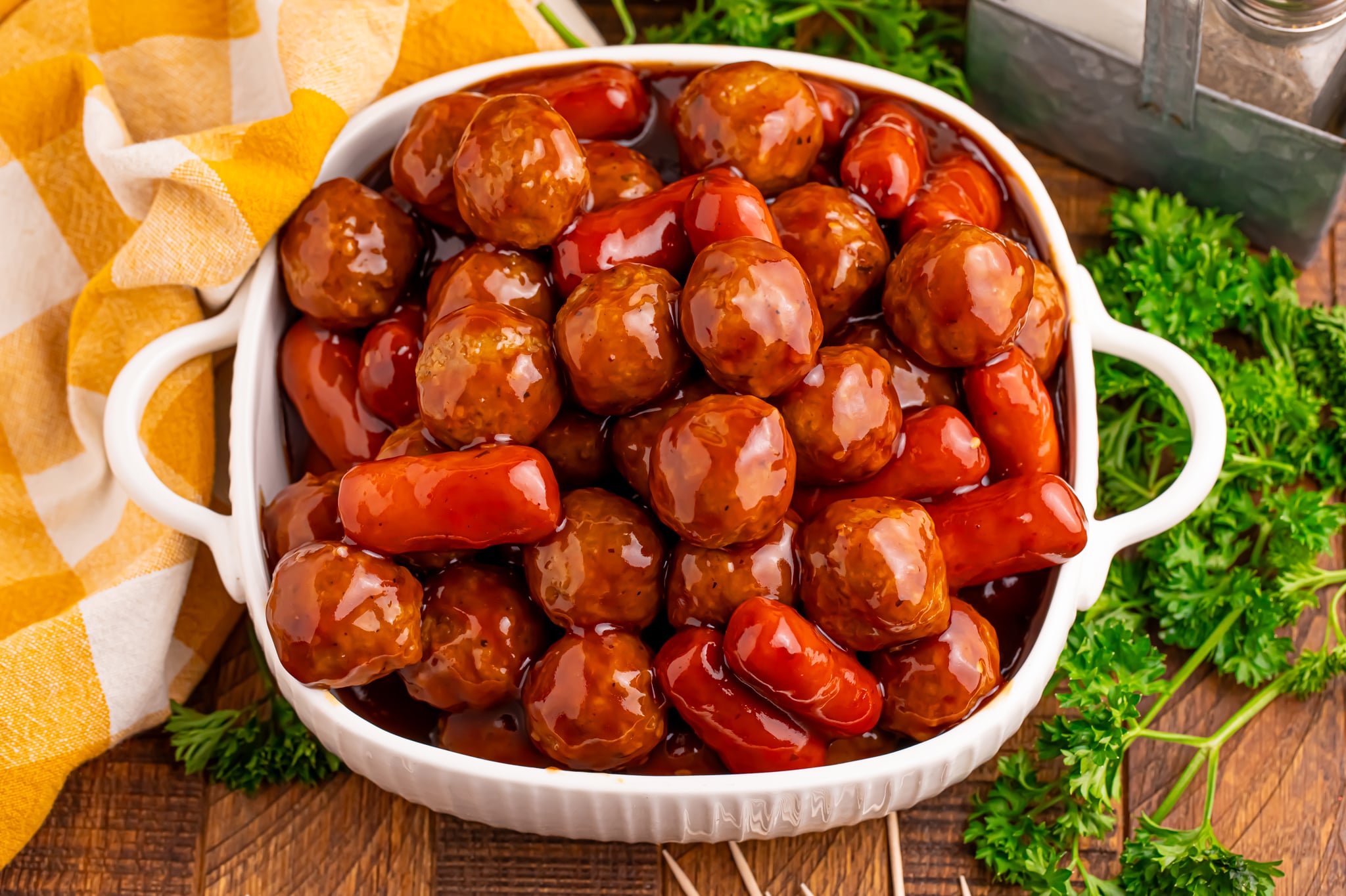 Overhead shot of Crockpot Teriyaki BBQ Cocktail Meatballs & Lil Smokies in a large white serving bowl 
