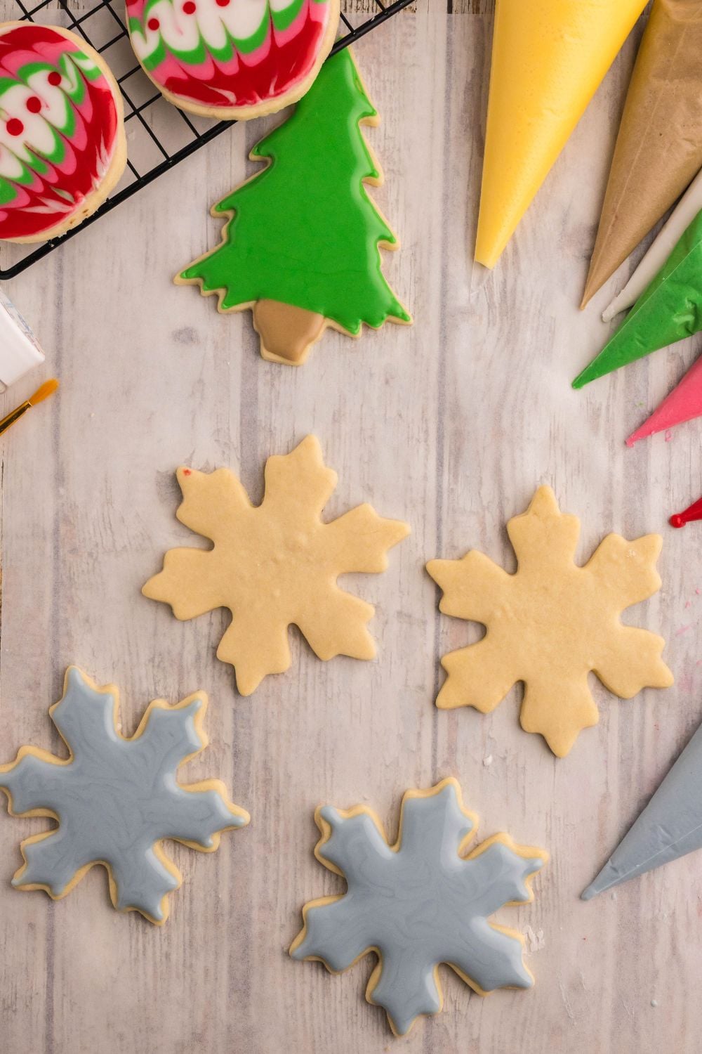 snowflake shape Decorated Sugar Cookies on a wooden table