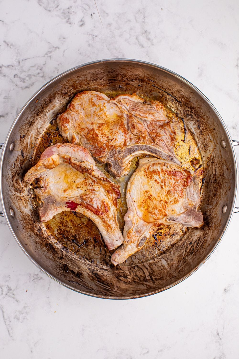 skillet with fried pork chops 
