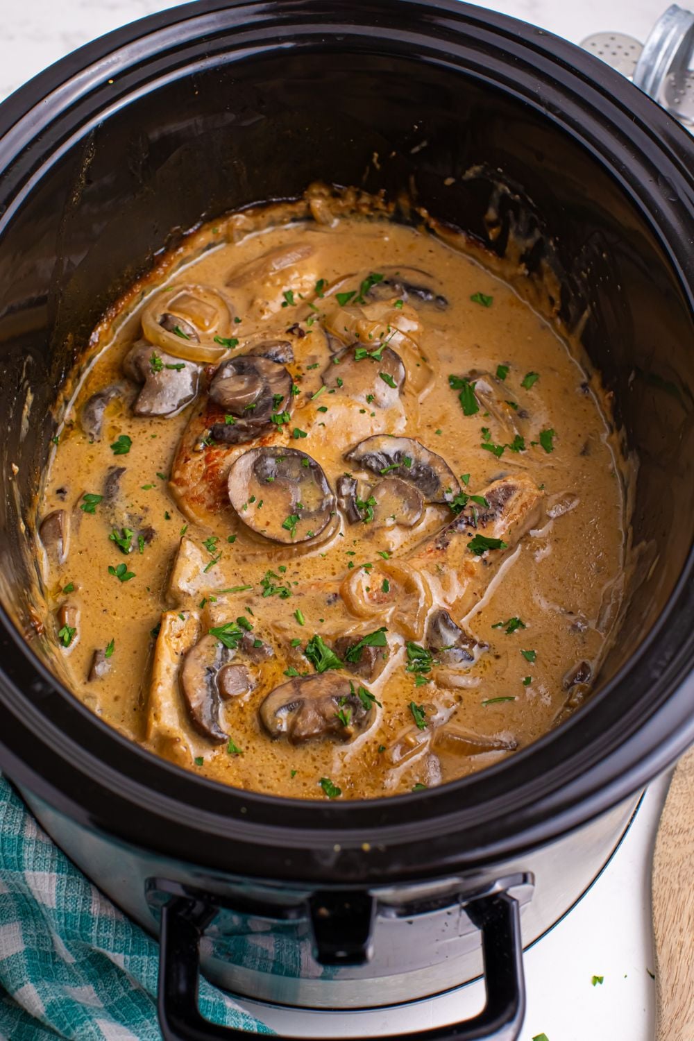 cooked Crockpot Smothered Pork Chops with Mushroom Gravy on table 