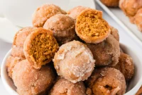 Baked Pumpkin Spice Donut Holes Rolled in Cinnamon Sugar