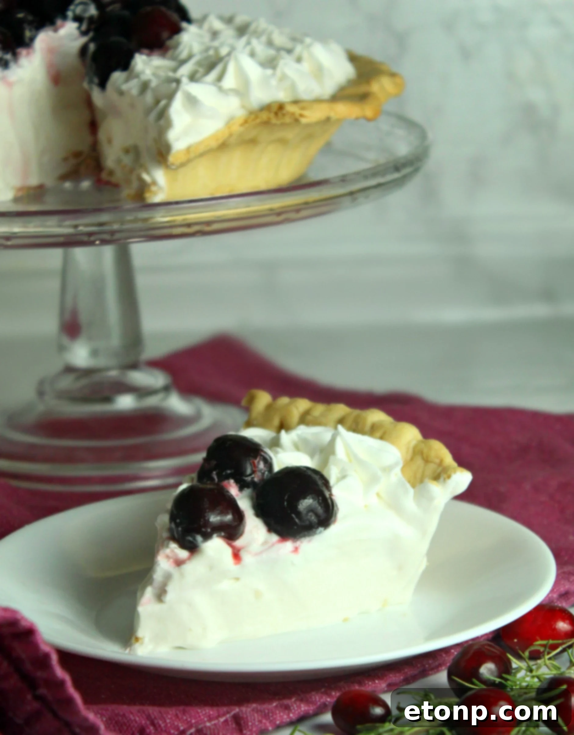 A generously sliced piece of White Christmas Pie, showcasing its creamy, fluffy interior and delicate golden crust, ready to be enjoyed as a light holiday dessert.