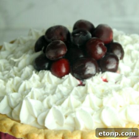 A delicious White Christmas Pie with cherry topping, showcasing its festive appeal.