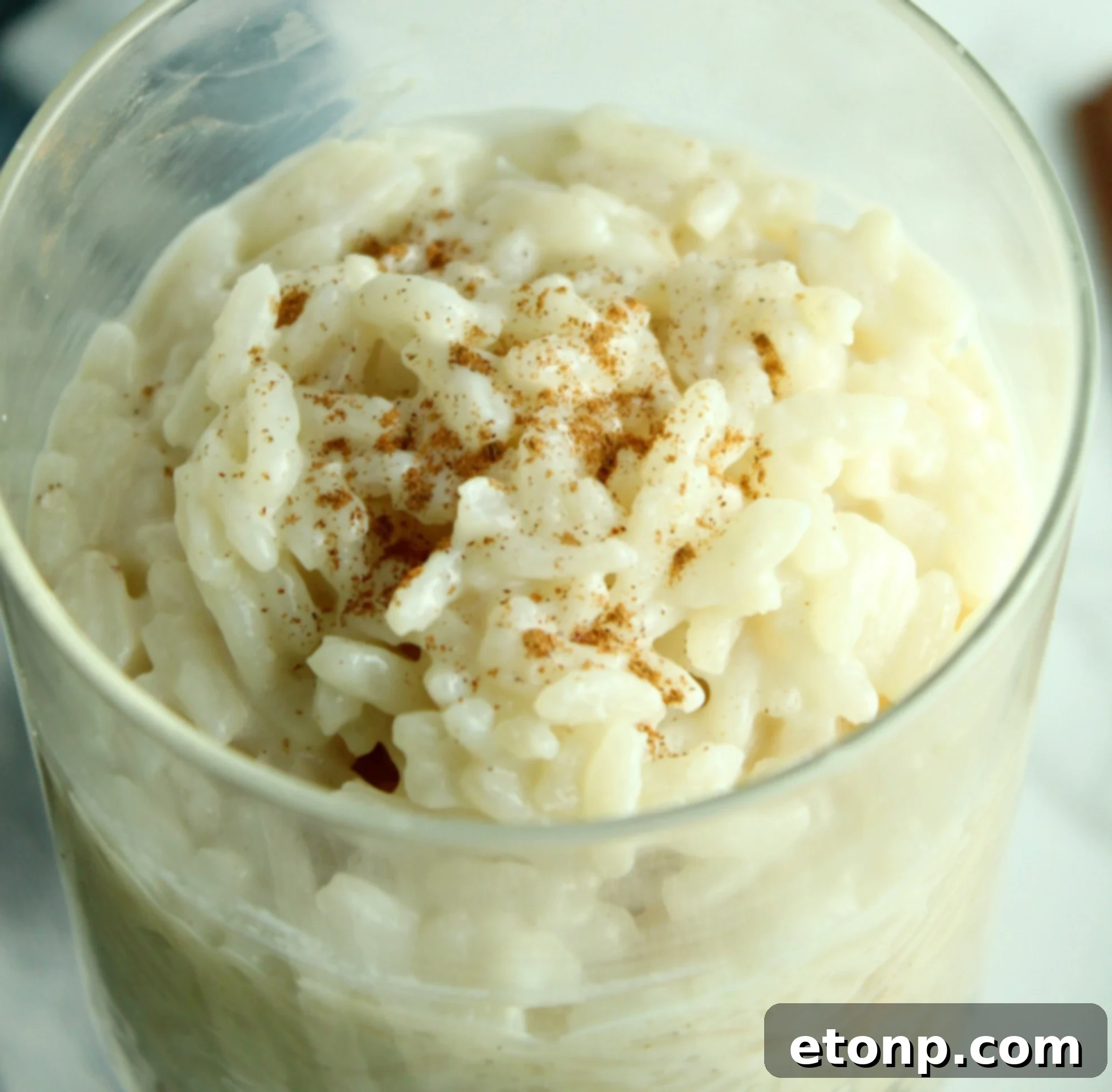 Various bowls of rice pudding on a wooden table