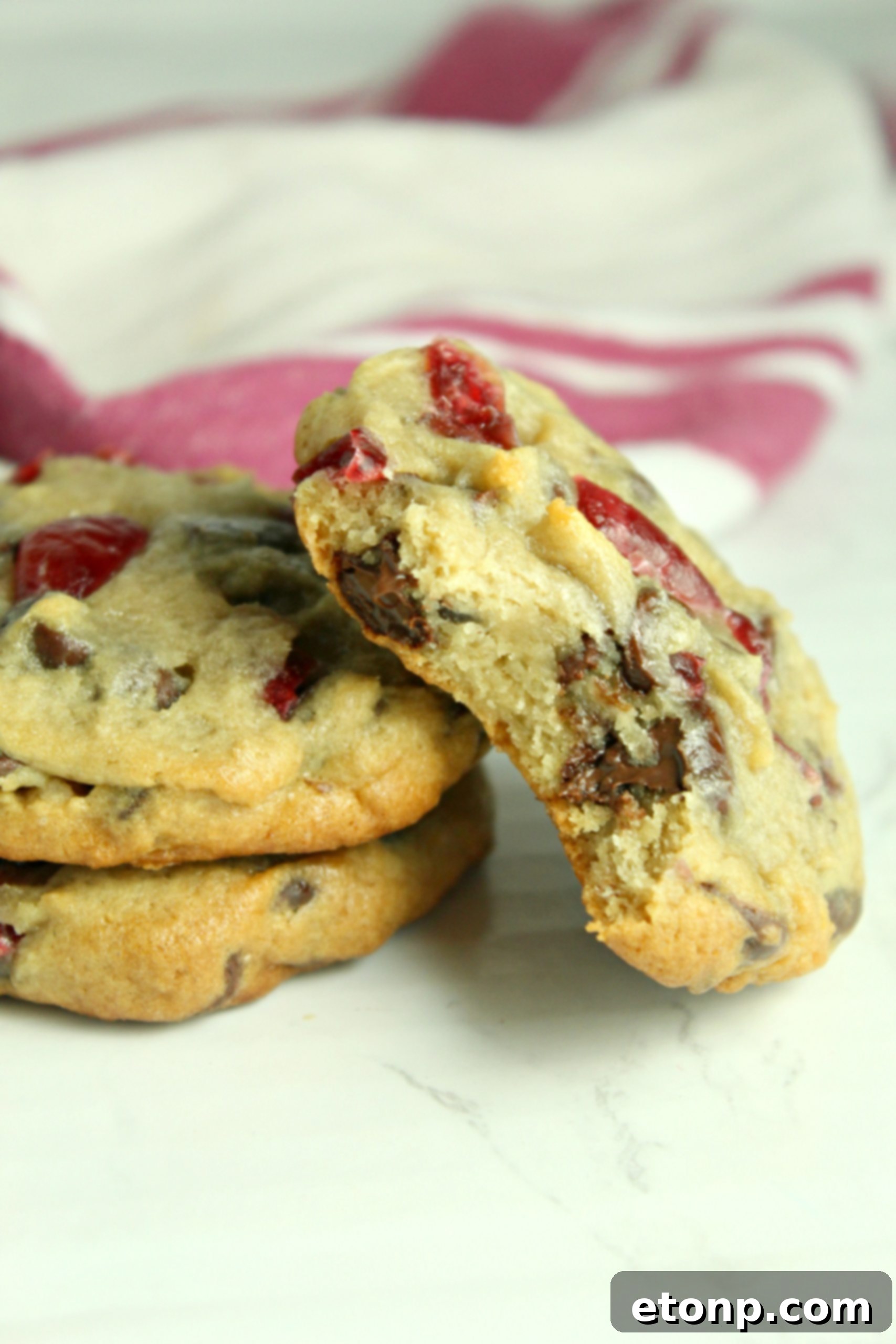 Cherries and chocolate chips on a cookie dough ball