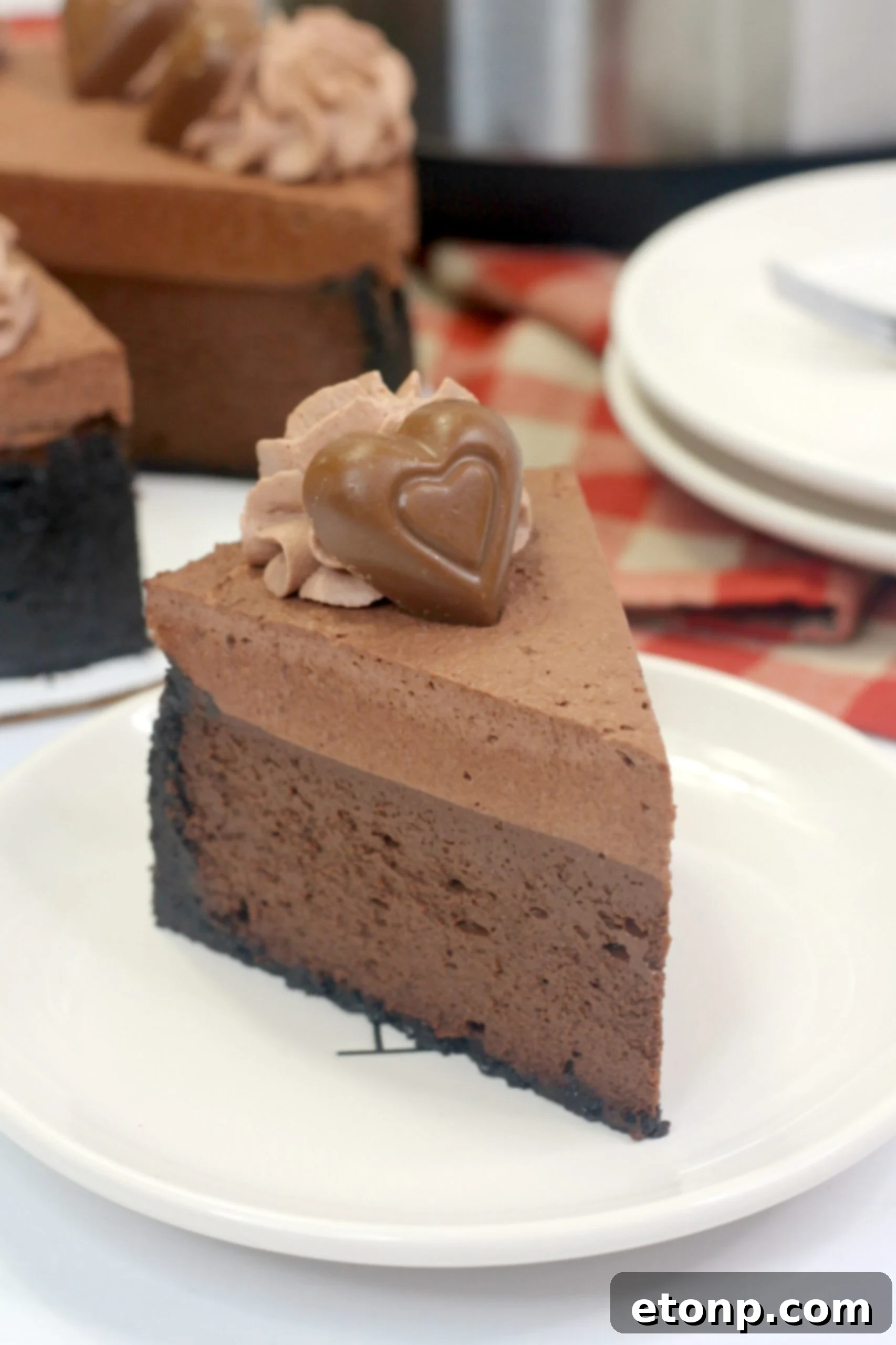 Overhead shot of the Instant Pot Triple Chocolate Godiva Cheesecake, garnished with chocolate hearts