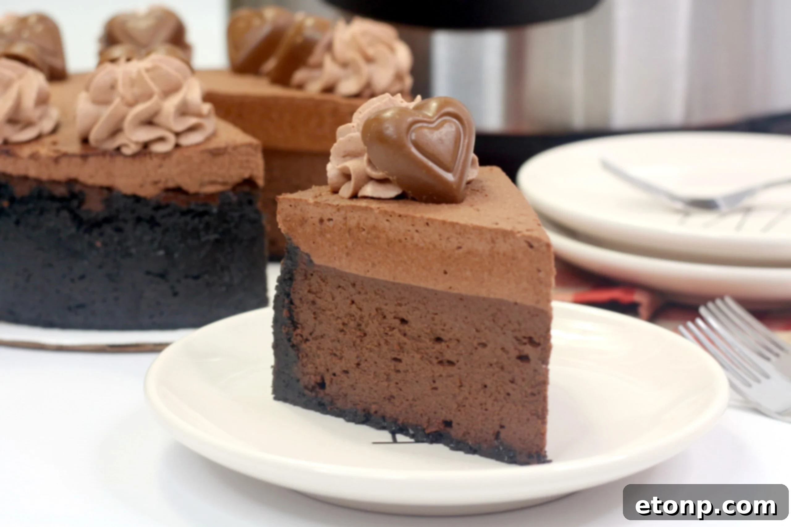 Another perspective of the Triple Chocolate Layered Godiva Cheesecake, emphasizing its generous toppings