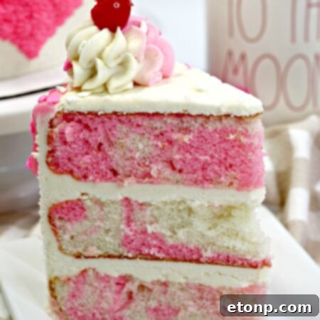 Valentine's Day Love Cake decorated with frosting and sprinkles.