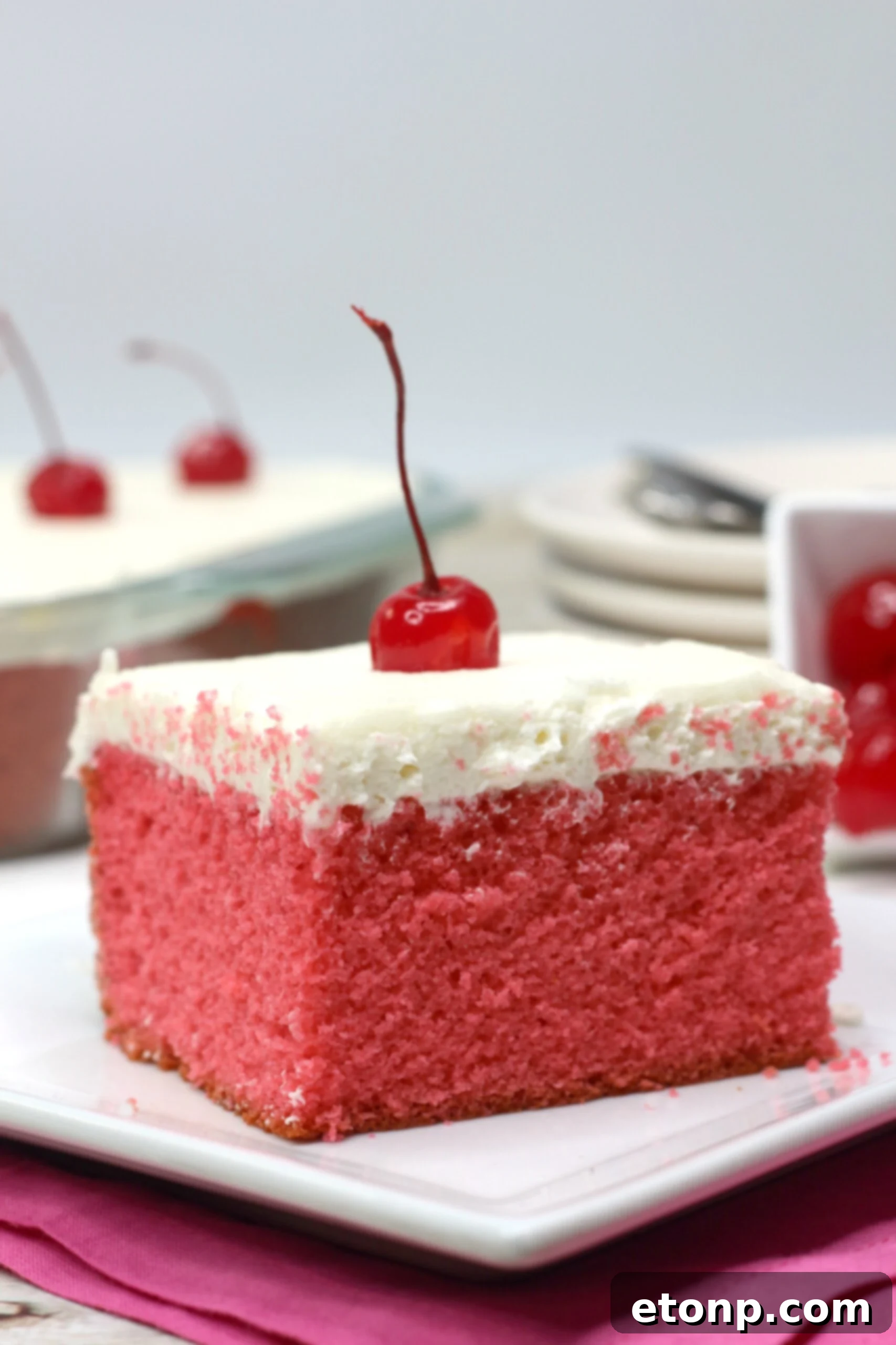 A freshly baked Very Cherry Cake, still in its pan, ready for frosting and serving, showcasing its golden-pink crust.