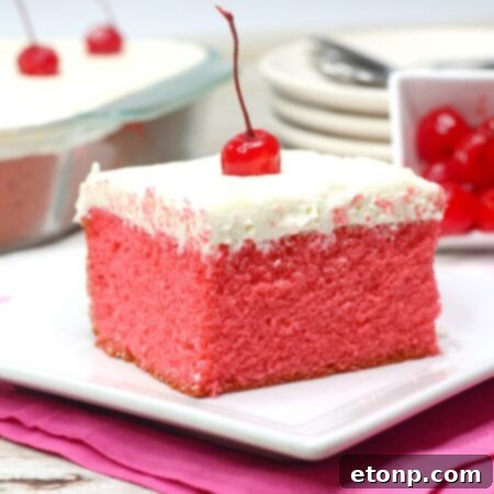 An overhead shot of the complete Very Cherry Cake with vanilla buttercream, garnished with maraschino cherries, demonstrating its appealing texture and readiness for serving.