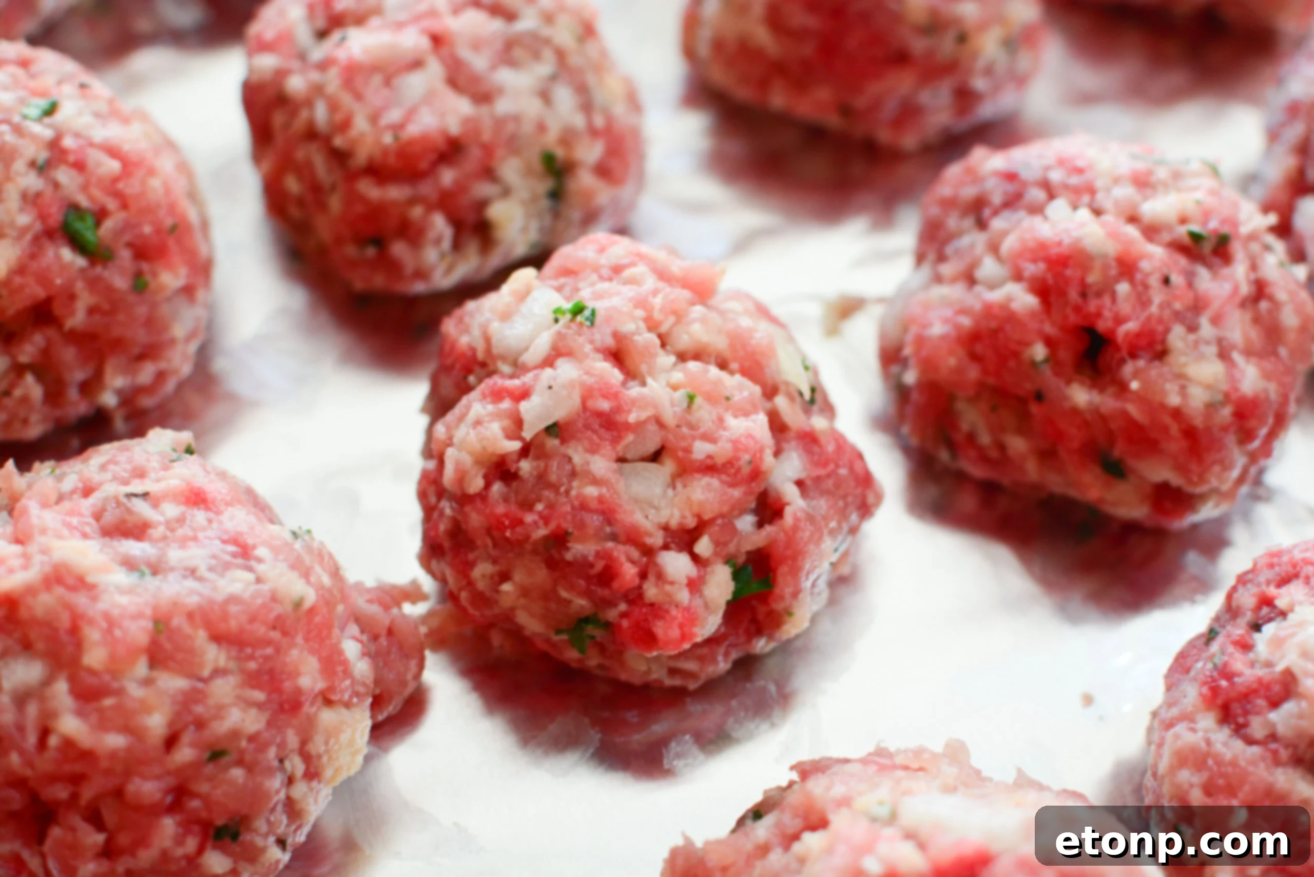 Grandma's Baked Italian Meatballs 4 Oven-baked Italian meatballs simmering in a rich tomato sauce, ready to be served.
