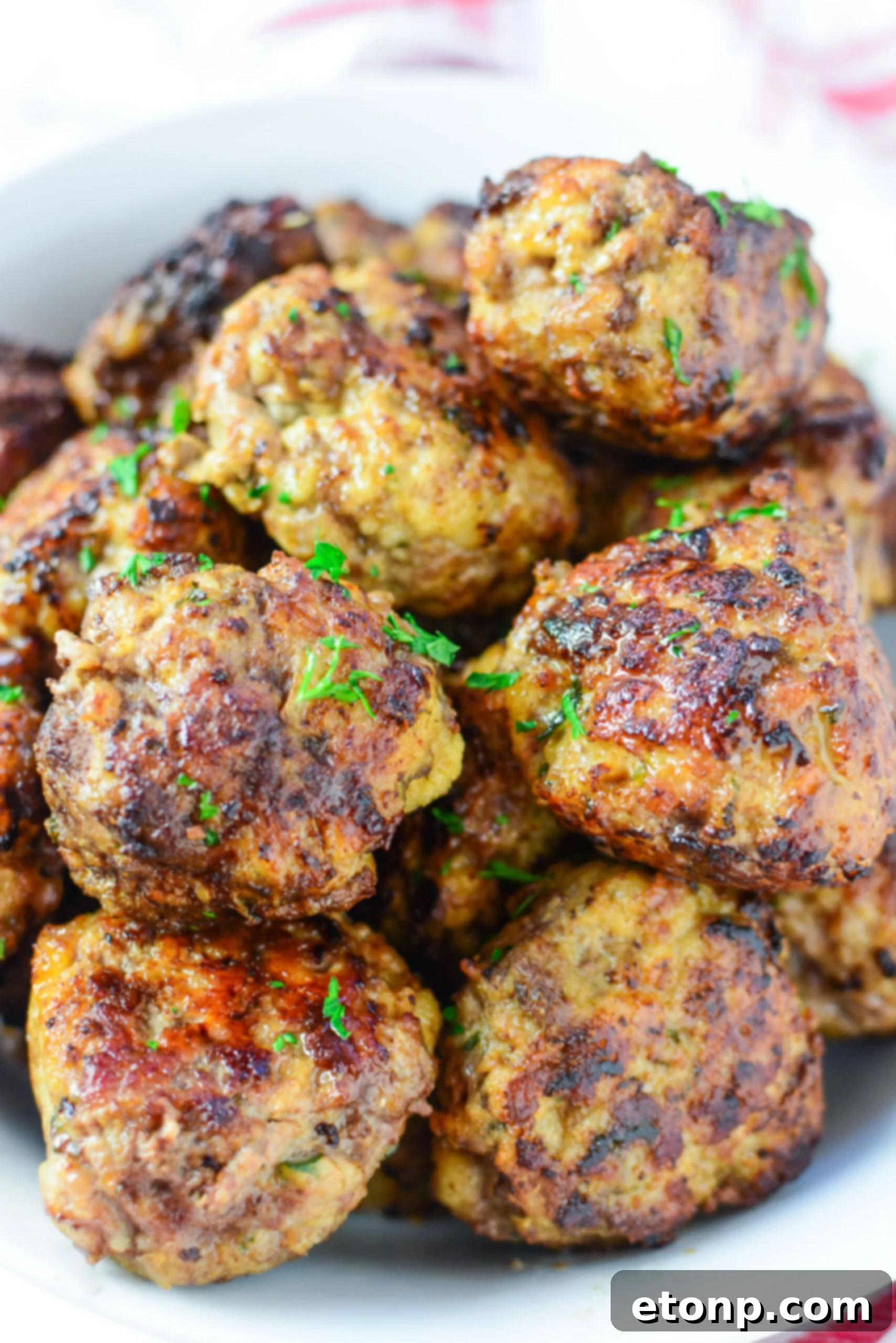 Grandma's Baked Italian Meatballs 6 Ingredients for Italian meatballs laid out on a wooden cutting board, including ground meat, bread, cheese, and spices.
