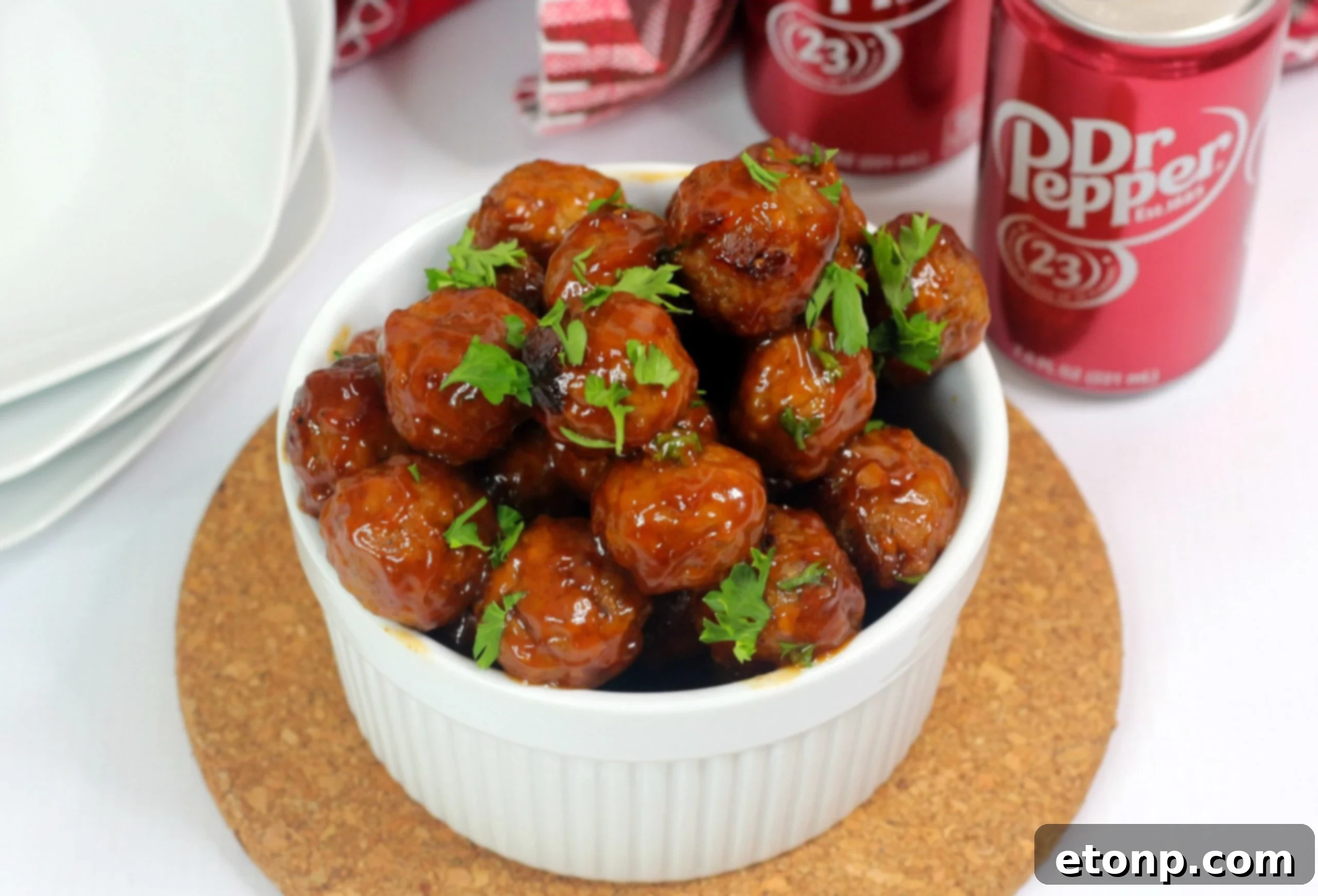 Close-up of Dr Pepper Meatballs arranged on a stylish serving platter with mini rolls and toothpicks, ready for a party.
