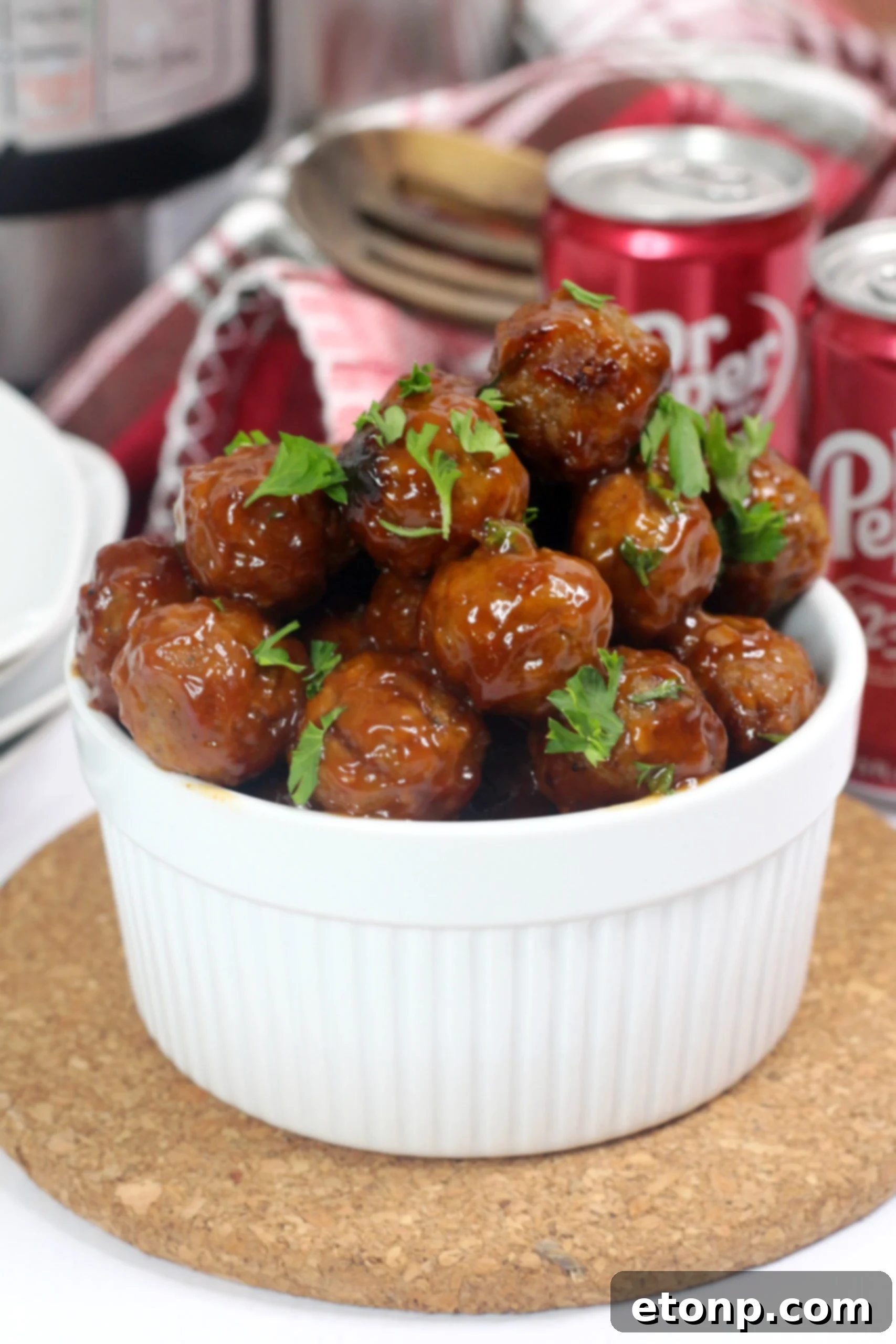 Dr Pepper Meatballs simmering in their rich, thick, flavorful sauce inside an Instant Pot, showing their tender texture.