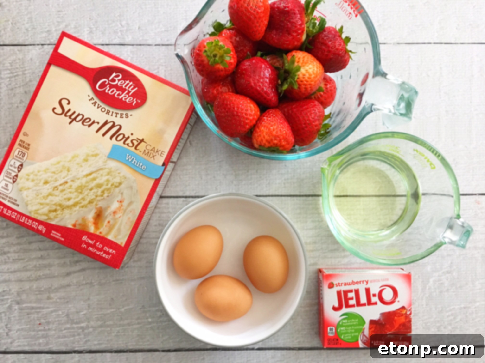 Full Strawberry Jello Cake showcasing its fluffy texture and vibrant pink hue from the Jello and fresh strawberries.