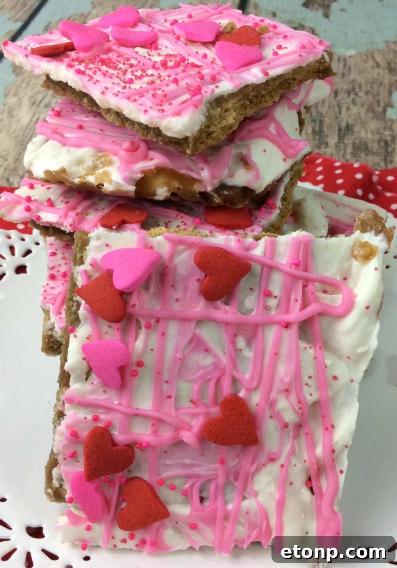 Close-up of Valentine's Day Crack dessert, showing white and pink chocolate with sprinkles on graham crackers.